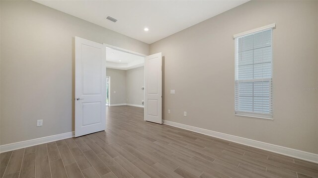 spare room with wood-type flooring