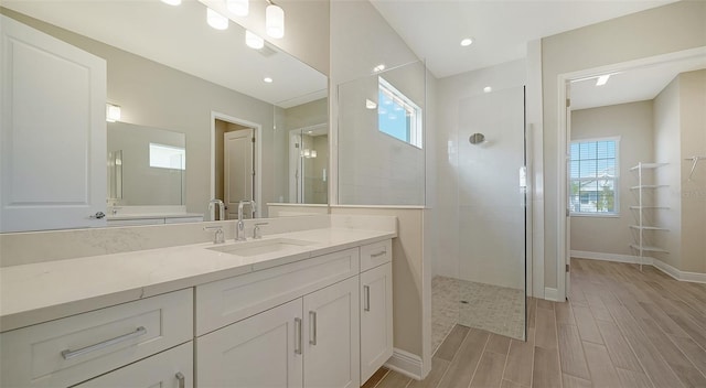 bathroom with vanity and a tile shower