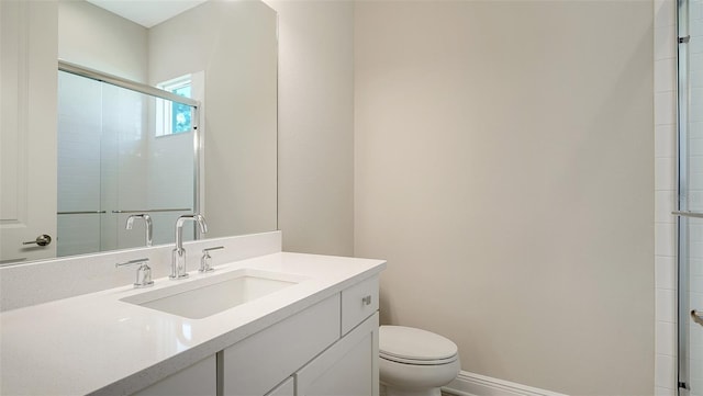 bathroom with vanity with extensive cabinet space and toilet