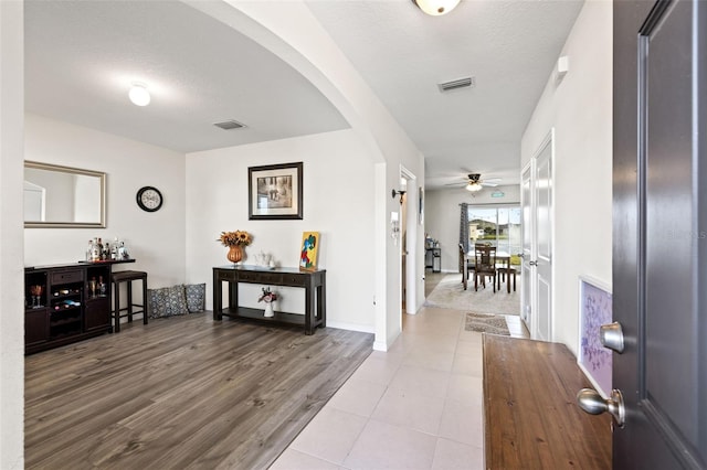 foyer entrance with hardwood / wood-style floors and a textured ceiling