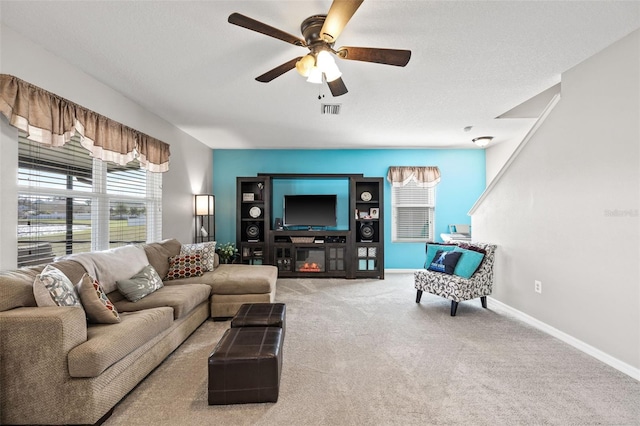 carpeted living room featuring ceiling fan