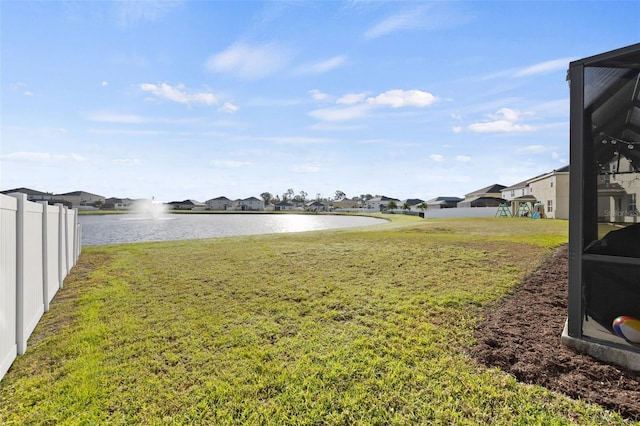 view of yard featuring a playground and a water view