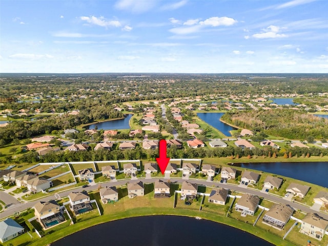 birds eye view of property with a water view