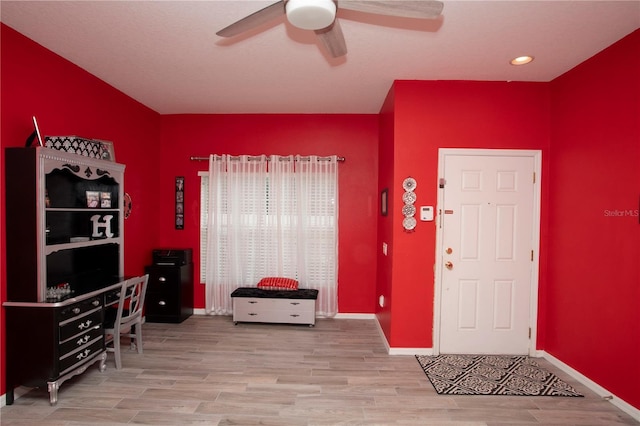 foyer entrance with ceiling fan and hardwood / wood-style flooring