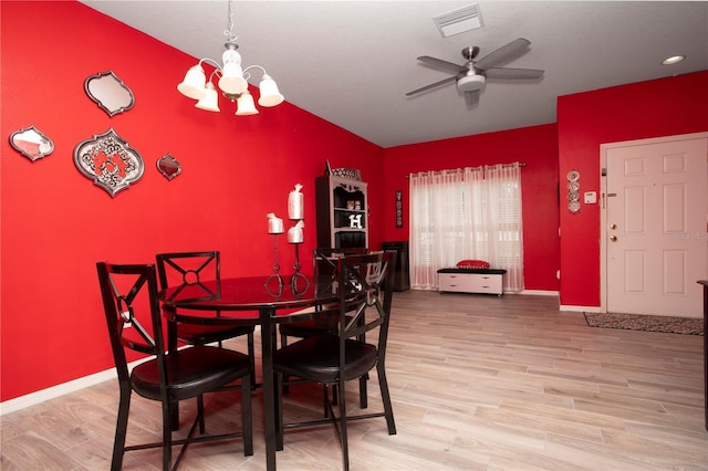 dining room featuring hardwood / wood-style flooring and ceiling fan with notable chandelier