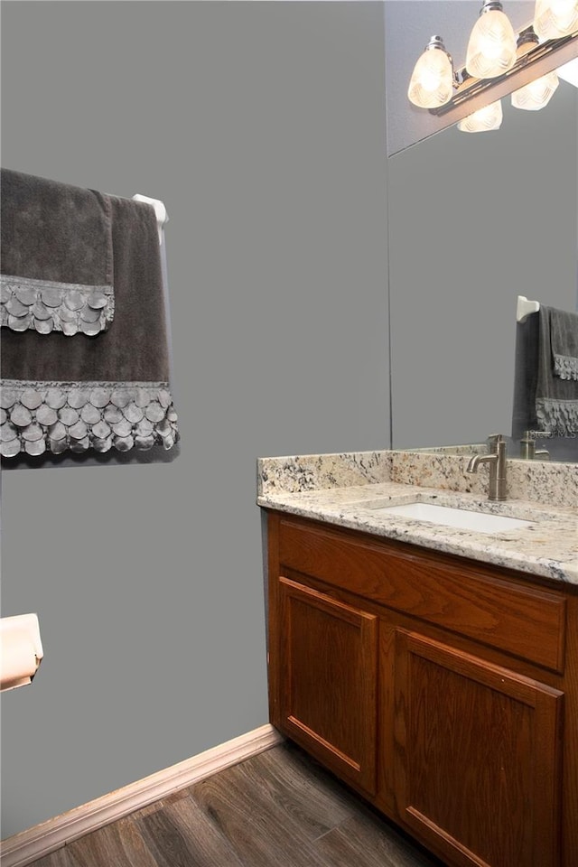 bathroom with hardwood / wood-style floors and vanity