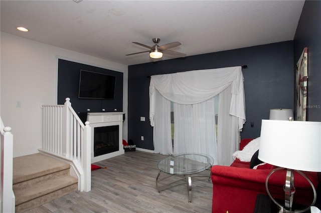 living room featuring ceiling fan and light wood-type flooring