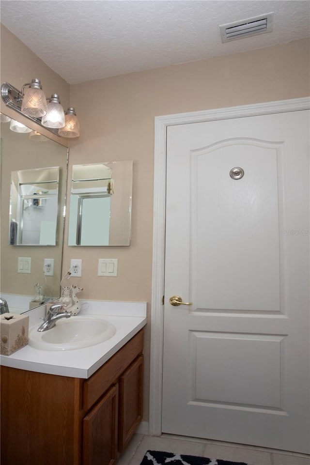 bathroom featuring vanity and a textured ceiling