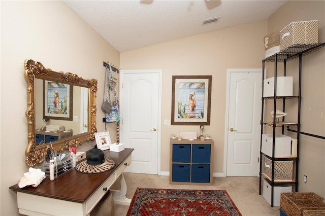 interior space featuring light colored carpet and lofted ceiling