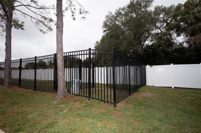 view of gate with a yard