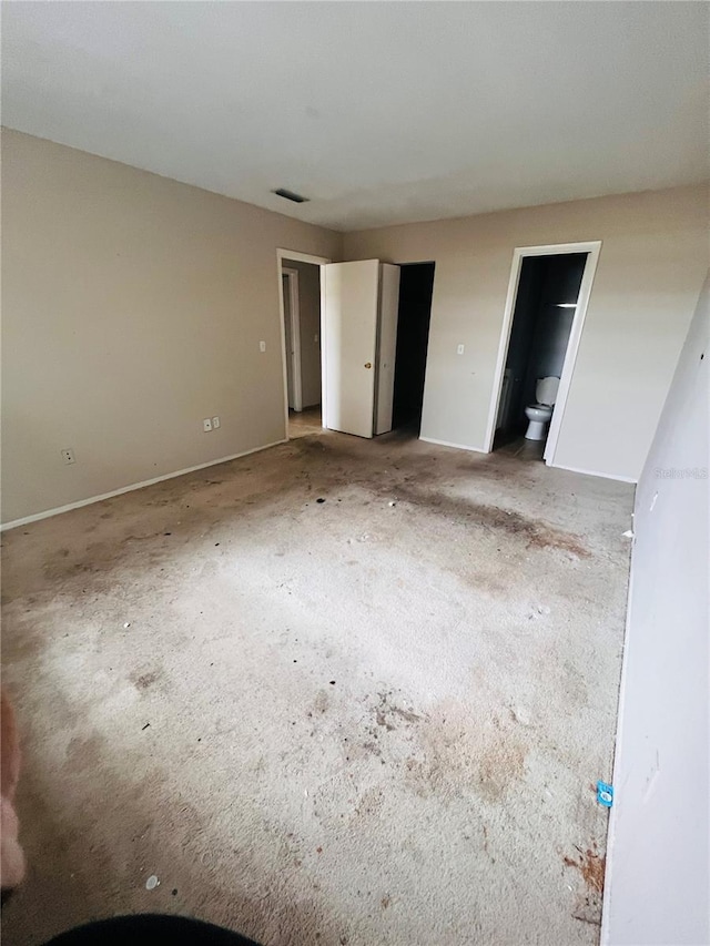 unfurnished bedroom with connected bathroom