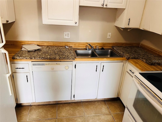 kitchen featuring white appliances, sink, white cabinets, and tile patterned floors