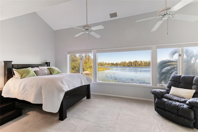 carpeted bedroom featuring a water view, lofted ceiling, and ceiling fan