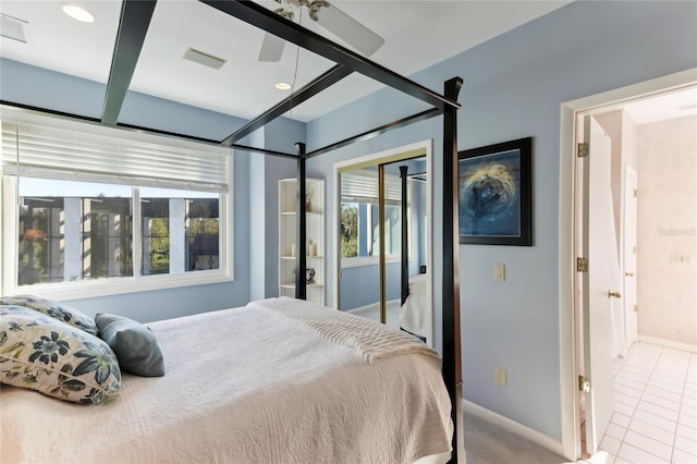 tiled bedroom featuring ceiling fan