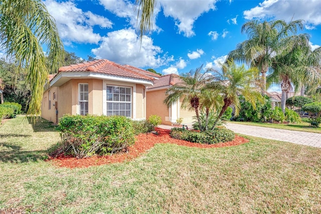 mediterranean / spanish-style house featuring a front lawn