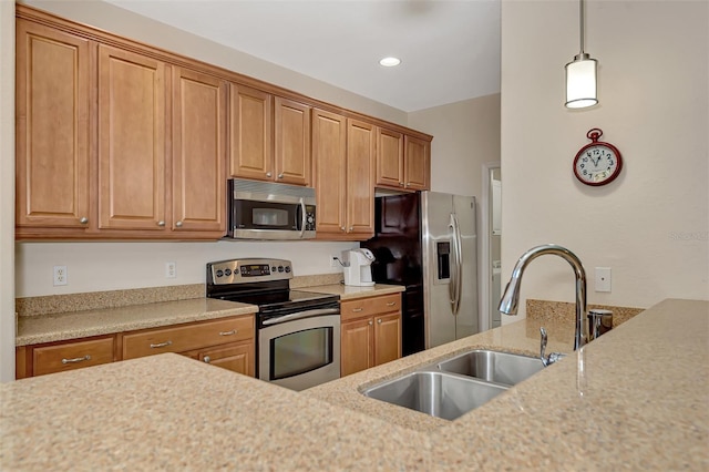 kitchen featuring appliances with stainless steel finishes, hanging light fixtures, light stone countertops, and sink