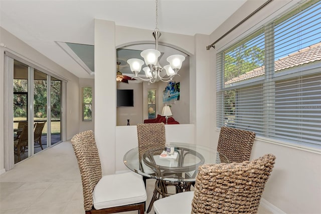 dining area with light tile floors and an inviting chandelier