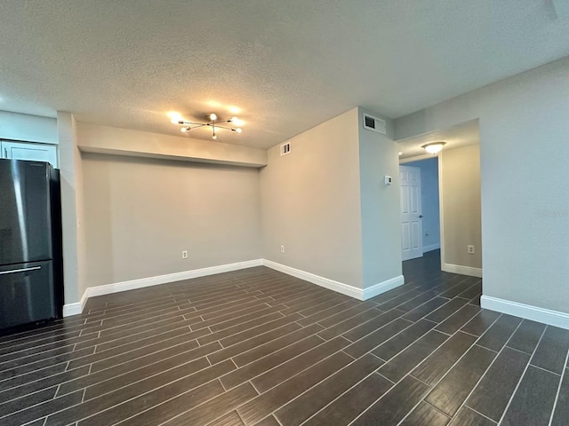 unfurnished room featuring a textured ceiling