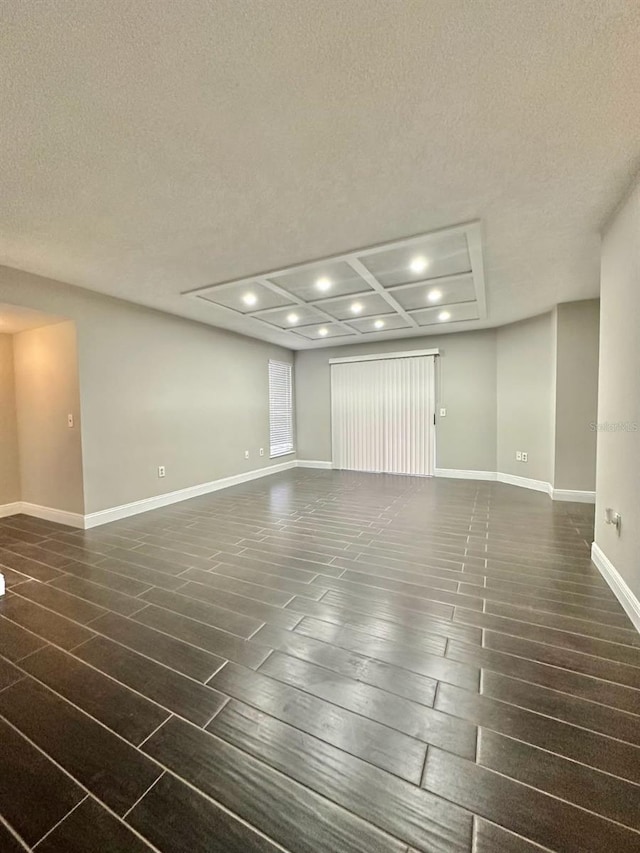 interior space featuring dark wood-type flooring and a textured ceiling