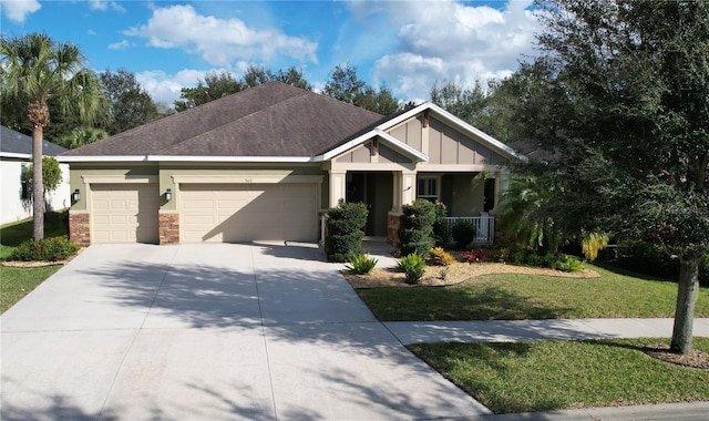 craftsman inspired home with a garage, covered porch, and a front yard