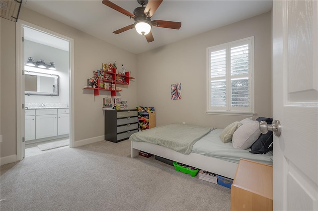 carpeted bedroom featuring ceiling fan and ensuite bath