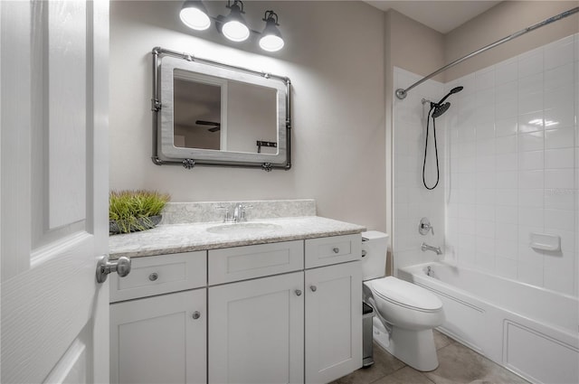 full bathroom with tiled shower / bath, vanity, toilet, and tile patterned flooring