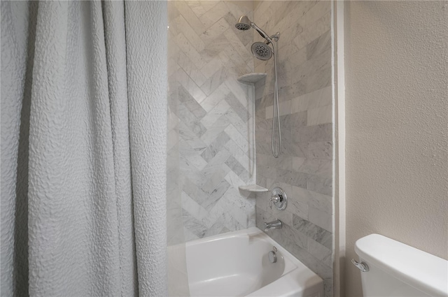 bathroom featuring shower / bath combination with curtain and toilet