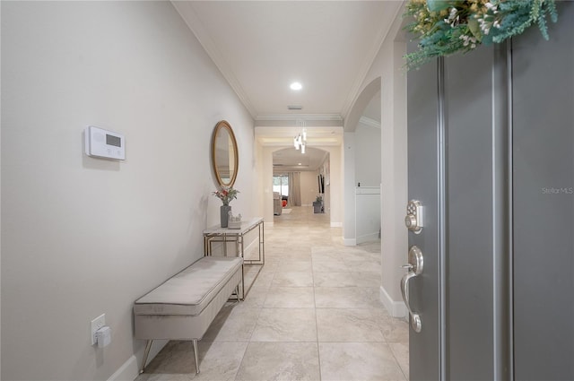 hallway featuring ornamental molding and light tile patterned floors