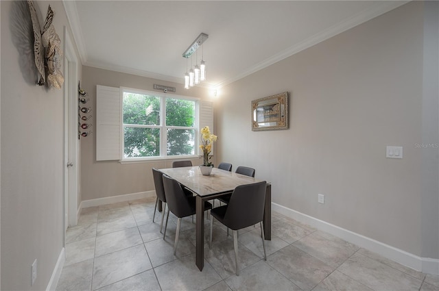 tiled dining space featuring ornamental molding