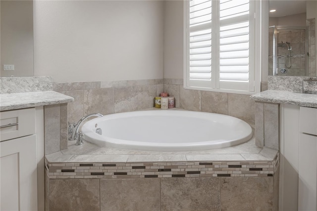 bathroom with vanity and separate shower and tub