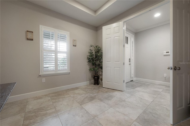 foyer entrance featuring crown molding