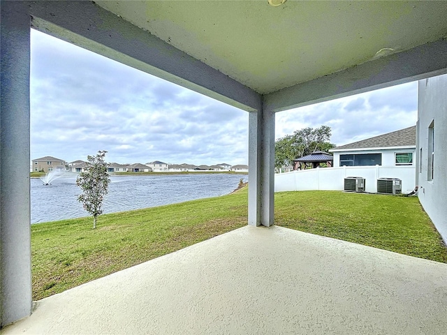 view of patio / terrace featuring a water view, fence, and central AC