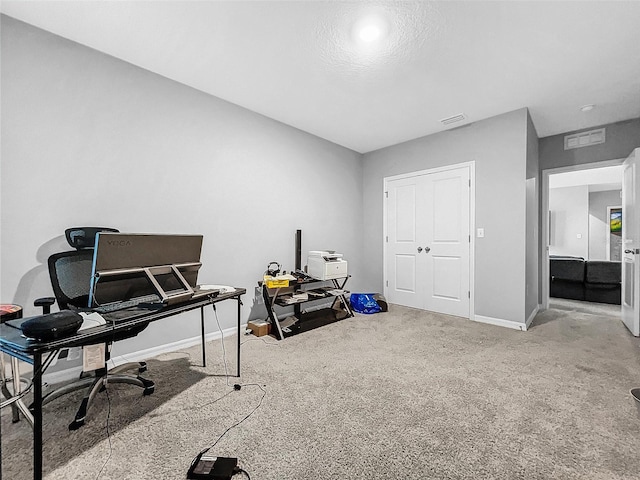 office space with carpet floors, baseboards, and visible vents