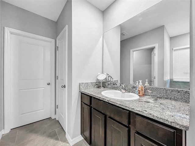 bathroom with tile patterned flooring, vanity, and visible vents