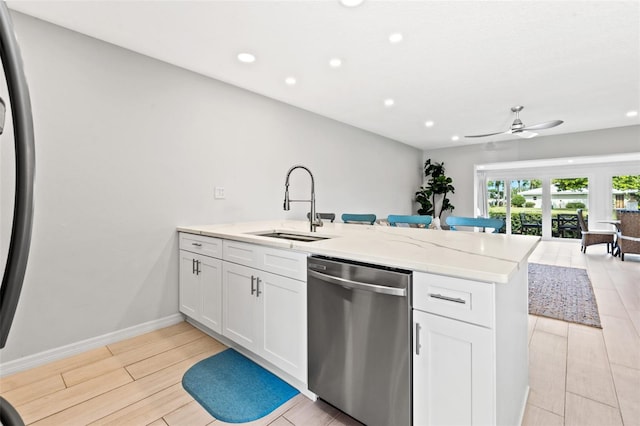 kitchen with ceiling fan, white cabinets, stainless steel dishwasher, and sink