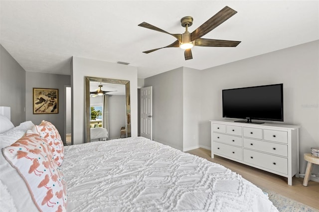 bedroom with ceiling fan and light hardwood / wood-style floors