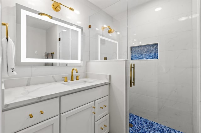 bathroom featuring tasteful backsplash, vanity, and a shower with door