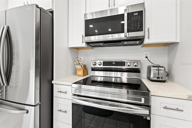 kitchen featuring stainless steel appliances and white cabinets