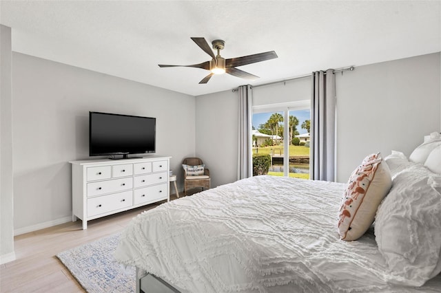 bedroom featuring light wood-type flooring, ceiling fan, and access to exterior