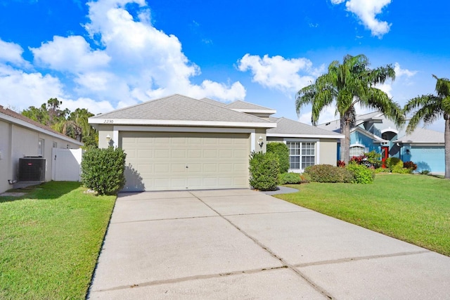 ranch-style home with central AC unit, driveway, stucco siding, a front lawn, and a garage