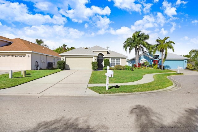 ranch-style home featuring a garage, a front yard, and central AC unit