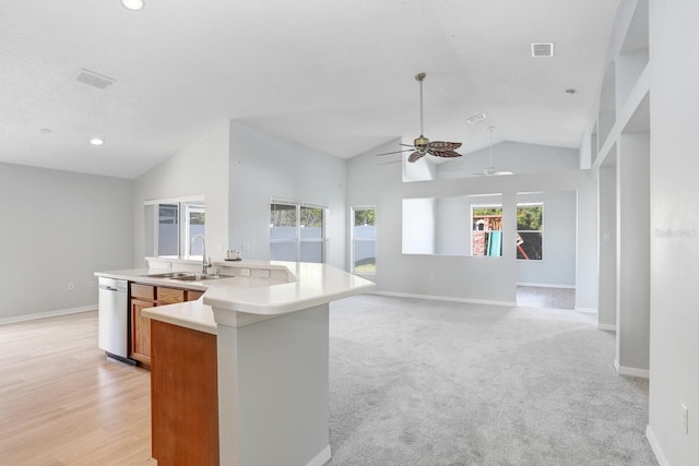 kitchen featuring light colored carpet, ceiling fan, sink, high vaulted ceiling, and a kitchen island with sink