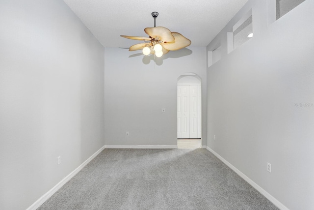 unfurnished room with light colored carpet and ceiling fan