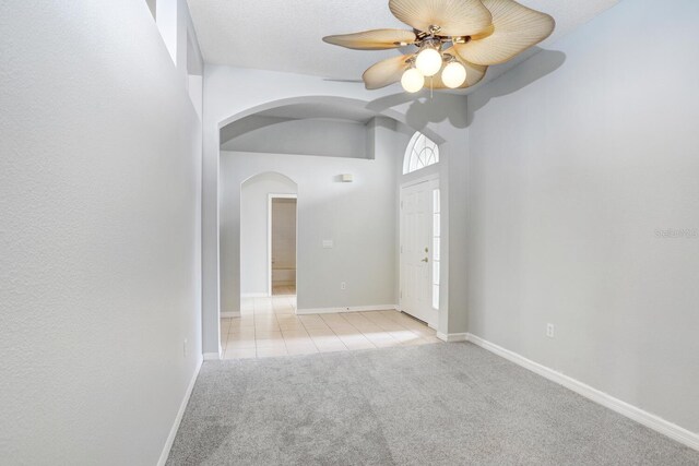 unfurnished room with light carpet and ceiling fan