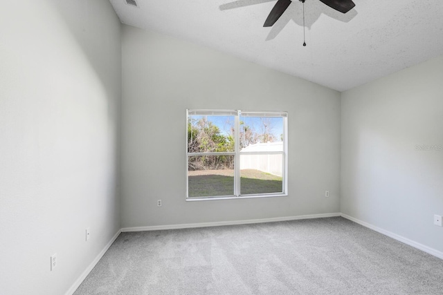 unfurnished room featuring lofted ceiling, a ceiling fan, baseboards, and carpet floors