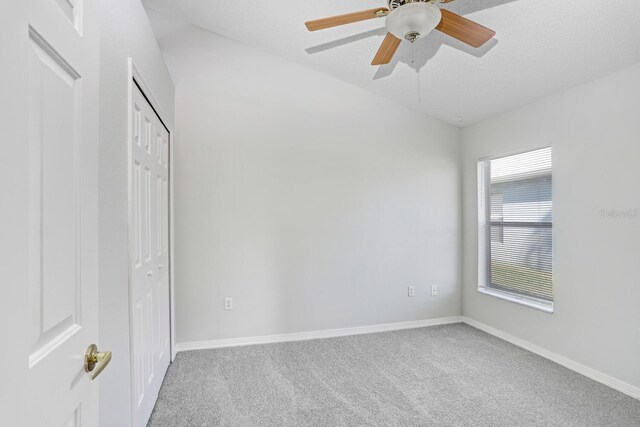 unfurnished bedroom featuring a closet, a textured ceiling, ceiling fan, and carpet