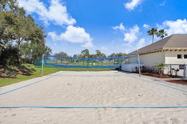 view of community with volleyball court and fence