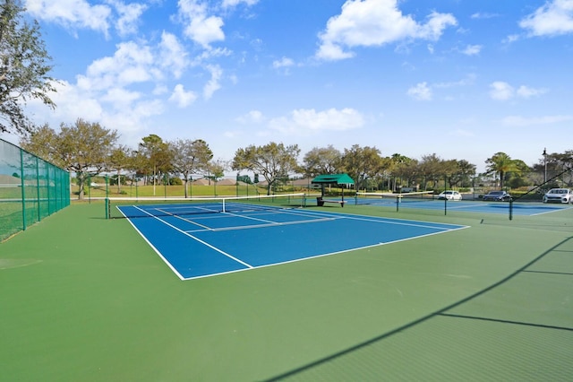 view of tennis court with fence