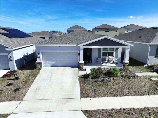 view of front of home featuring a porch and a garage