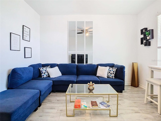 living room featuring ceiling fan and light hardwood / wood-style floors